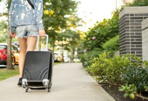 Woman walking away with suitcase
