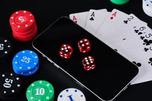 Playing cards, poker chips and dice on a phone