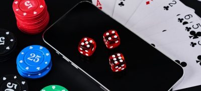 Playing cards, poker chips and dice on a phone