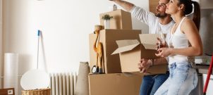 Couple standing in house with moving boxes