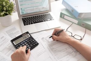 Desk with a computer, calculator and tax documents