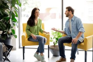 Man and woman sitting in chairs talking