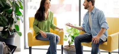 Man and woman sitting in chairs talking